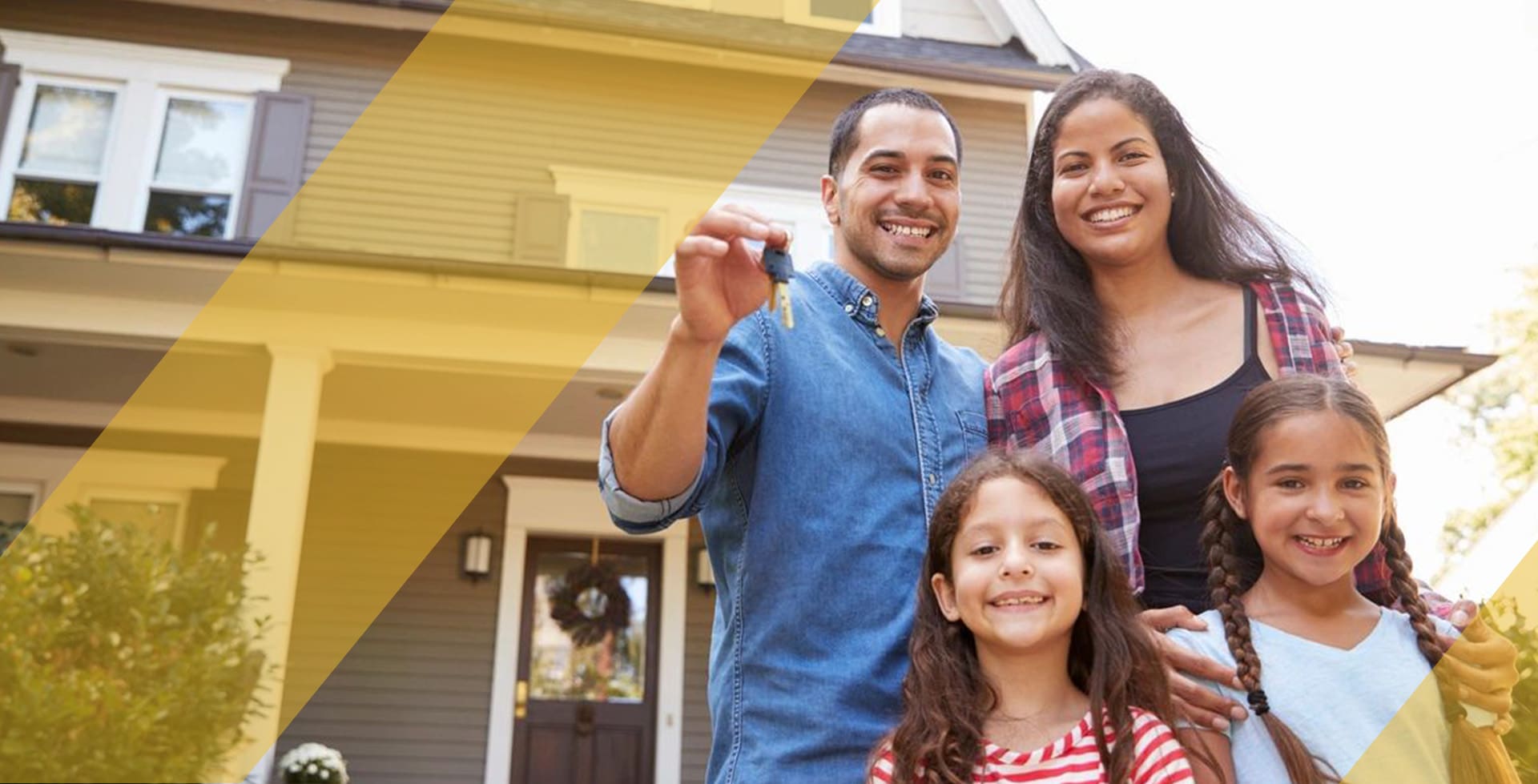 A family is standing in front of their home.